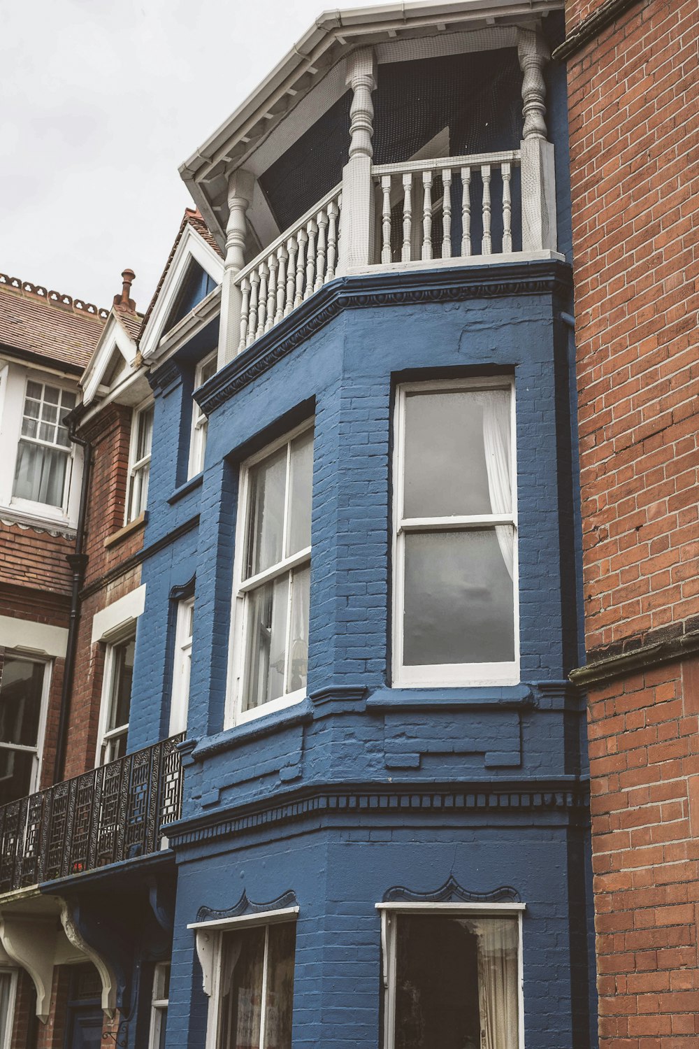 a blue building with a balcony and balconies