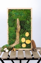 Natural textured eco-resin plaques shaped like deer and little houses lying on a rustic wooden surface.