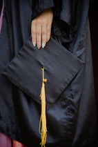 A close-up of hands holding a globe and graduation cap, symbolizing global education opportunities.