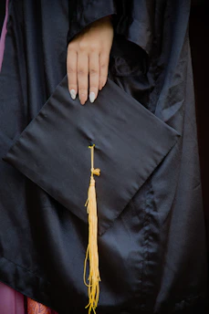 A close-up of hands holding a globe and graduation cap, symbolizing global education opportunities.