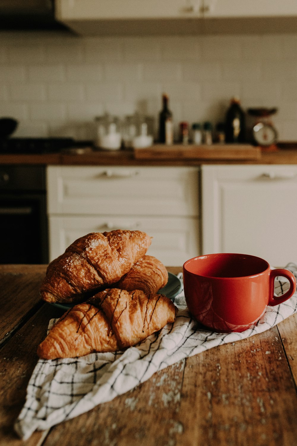 croissants and a cup of coffee on a kitchen table