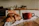 A cozy kitchen scene with a bright handmade ceramic mug filled with steaming coffee on a wooden table.