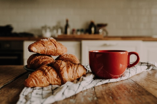 An inviting kitchen scene with artisanal mugs and a freshly baked loaf of bread.