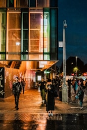 Dynamic urban street scene with colorful graffiti walls and pedestrians crossing under soft evening light.