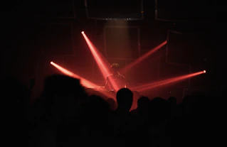 a person on a stage with red lights