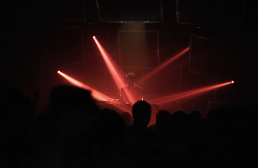 Red beams over a crowd in the dark