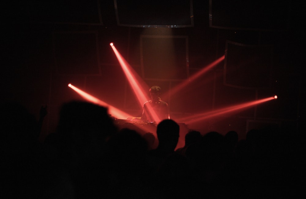 a person on a stage with red lights