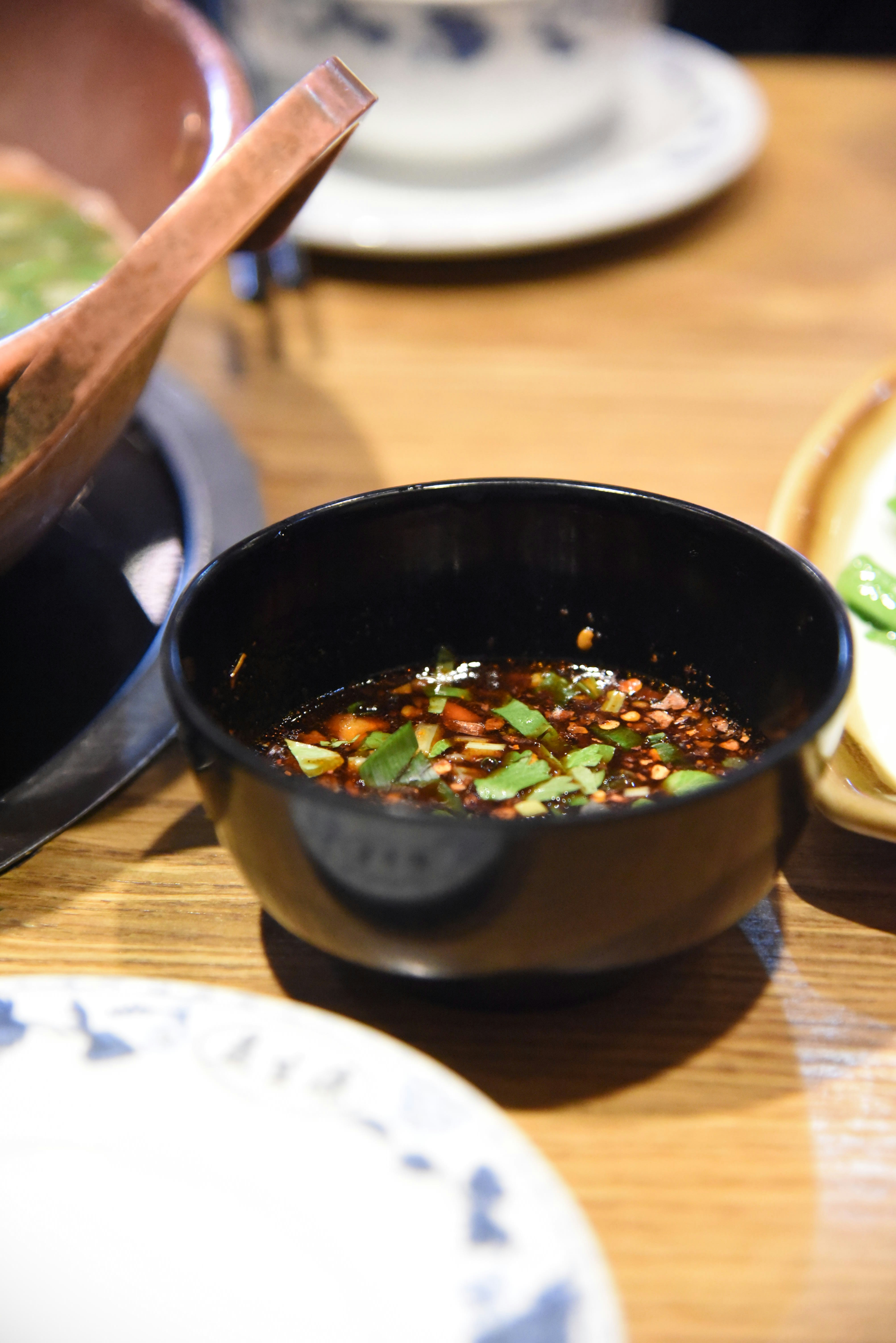 a bowl of soup on a wooden table