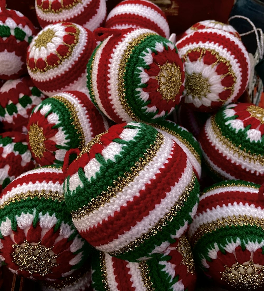 a pile of red and green christmas ornaments