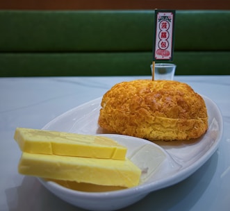 Freshly baked pineapple buns with a cup of traditional Hong Kong-style milk tea.