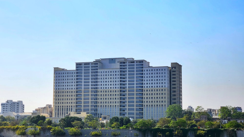 a large white building next to a body of water