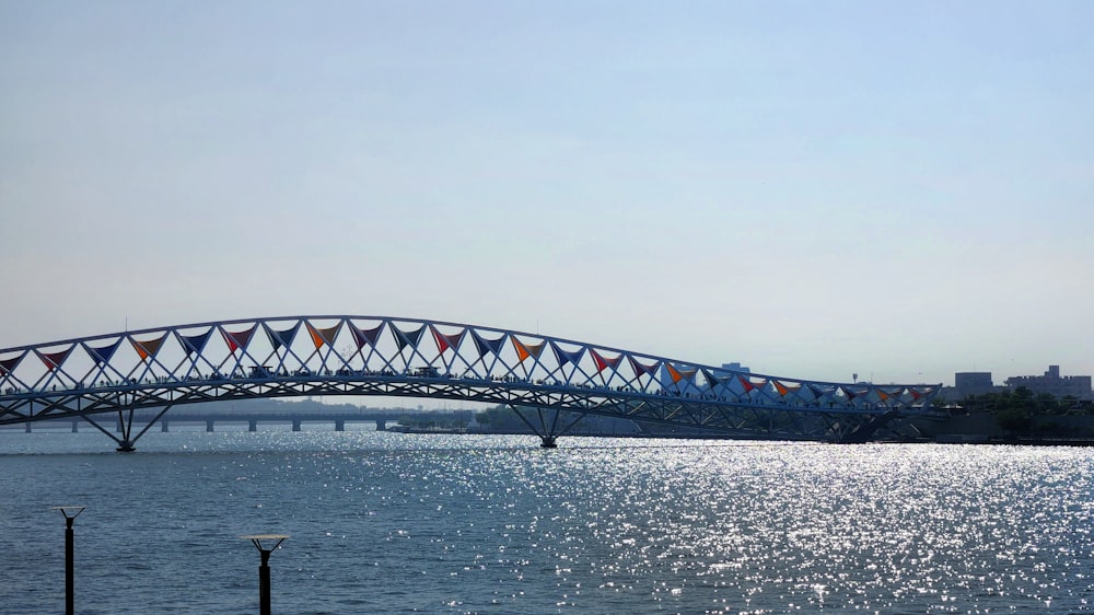 a bridge over a body of water with buildings in the background