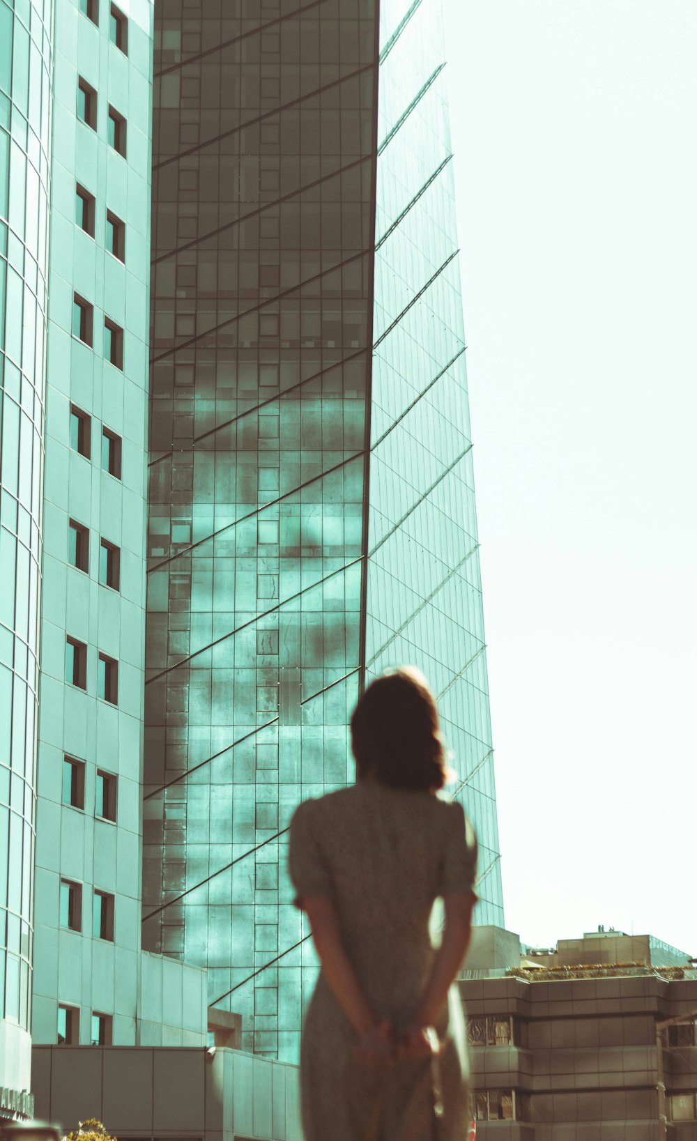 a woman standing in front of a tall building