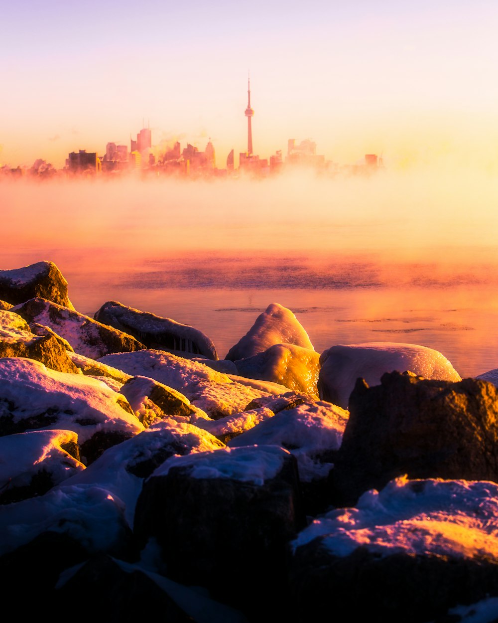 a view of a city in the distance covered in snow