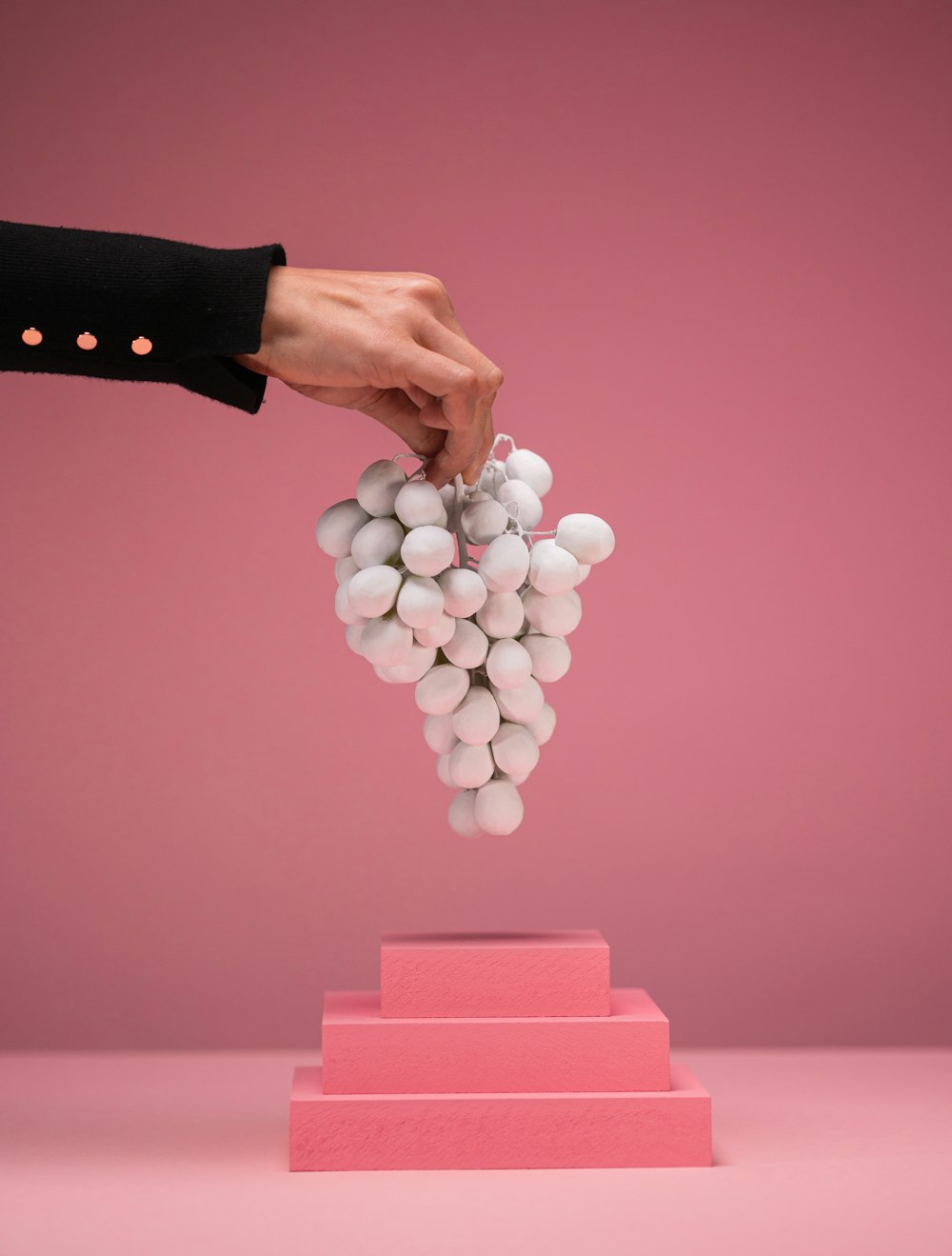 a person holding a bunch of white balls in their hand