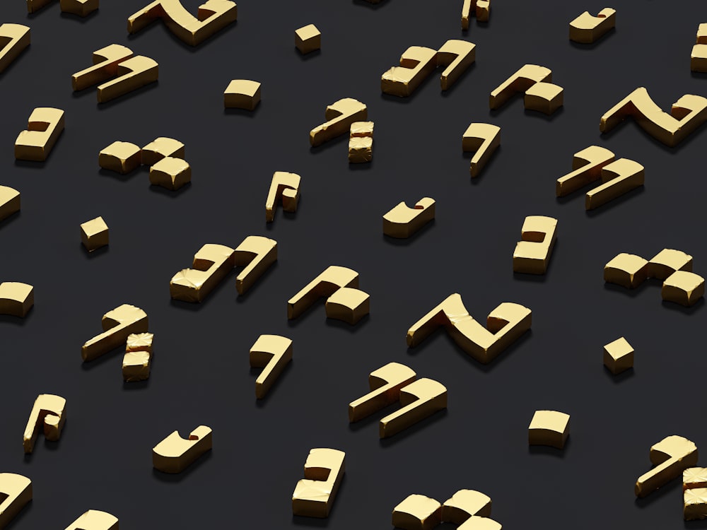 a group of gold letters and numbers on a black surface