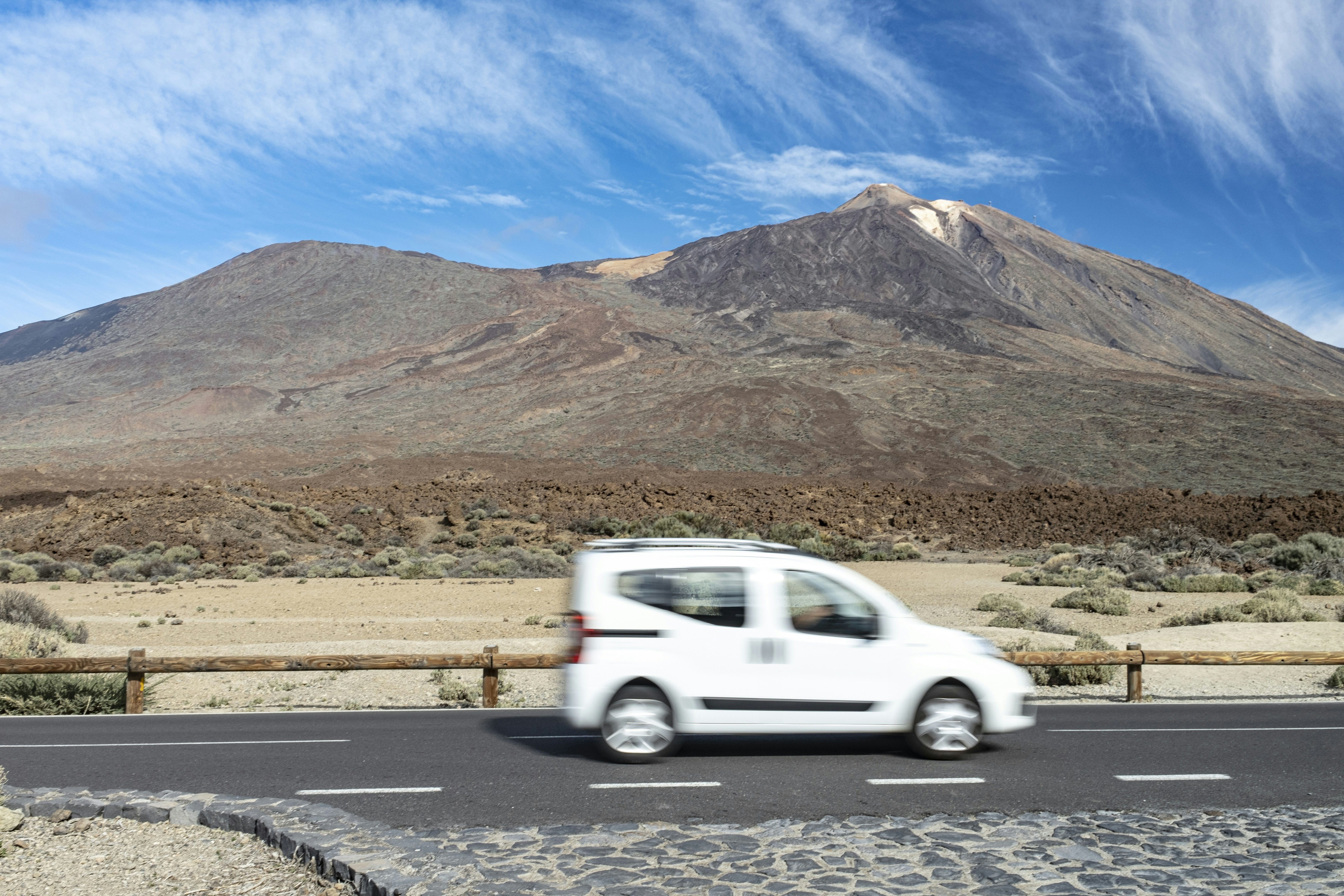 A professional taxi driving toward Mount Kilimanjaro on a paved road - moshi taxi