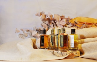 three bottles of cologne sitting on top of a table