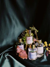 A serene still life featuring golden perfume bottles with beige accents on a wooden table