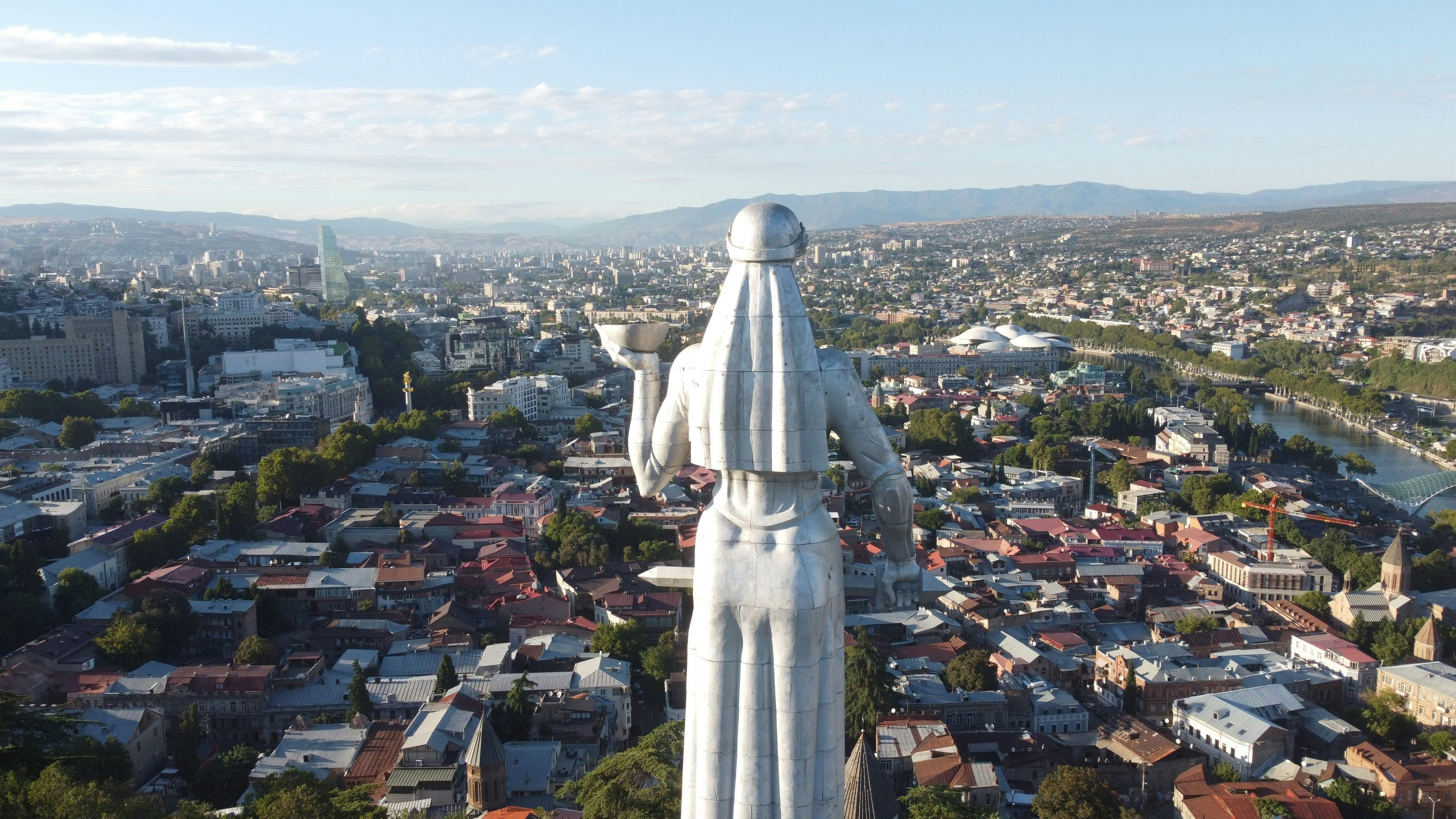 a statue of a person overlooking a city
