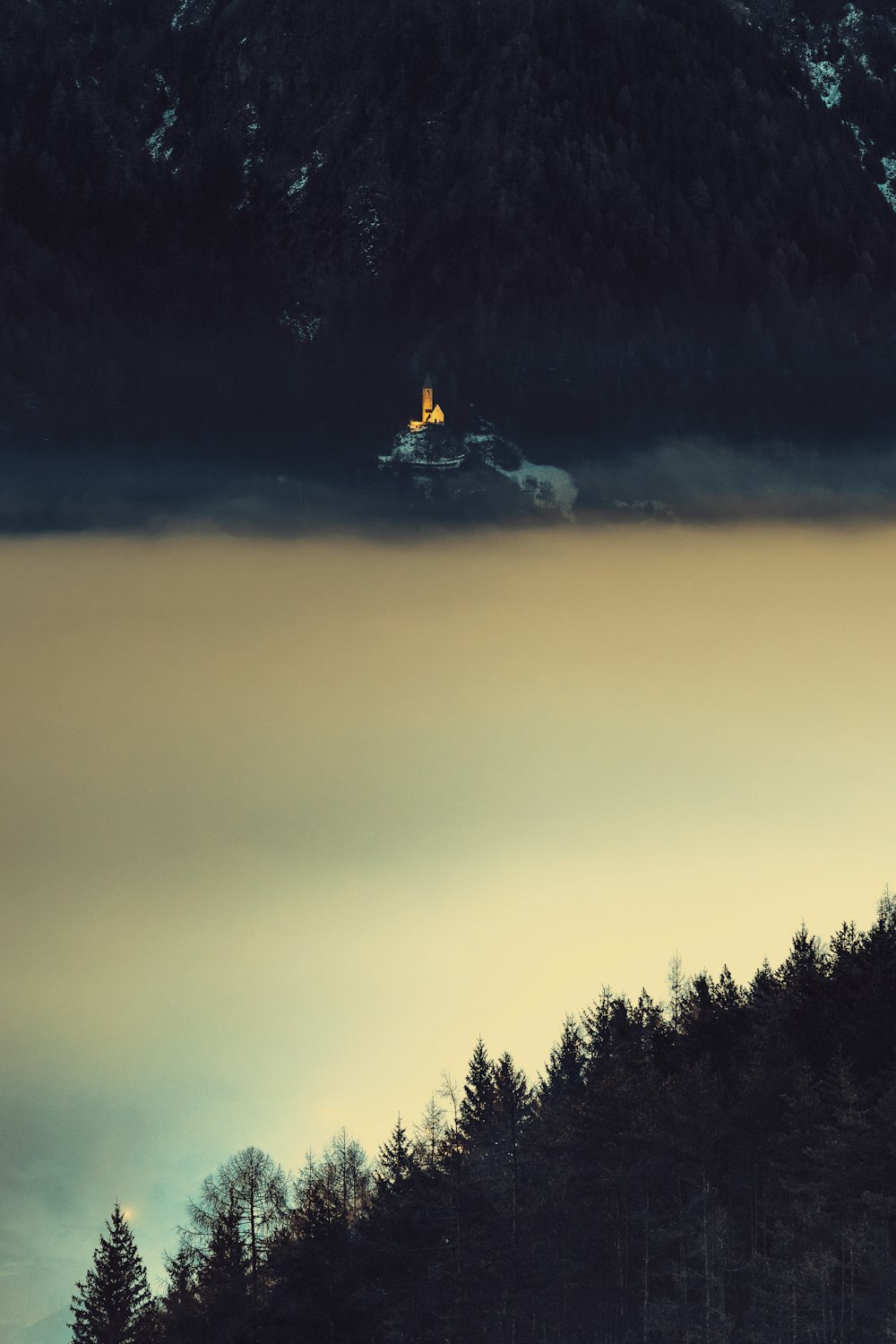 a boat floating on top of a lake surrounded by forest