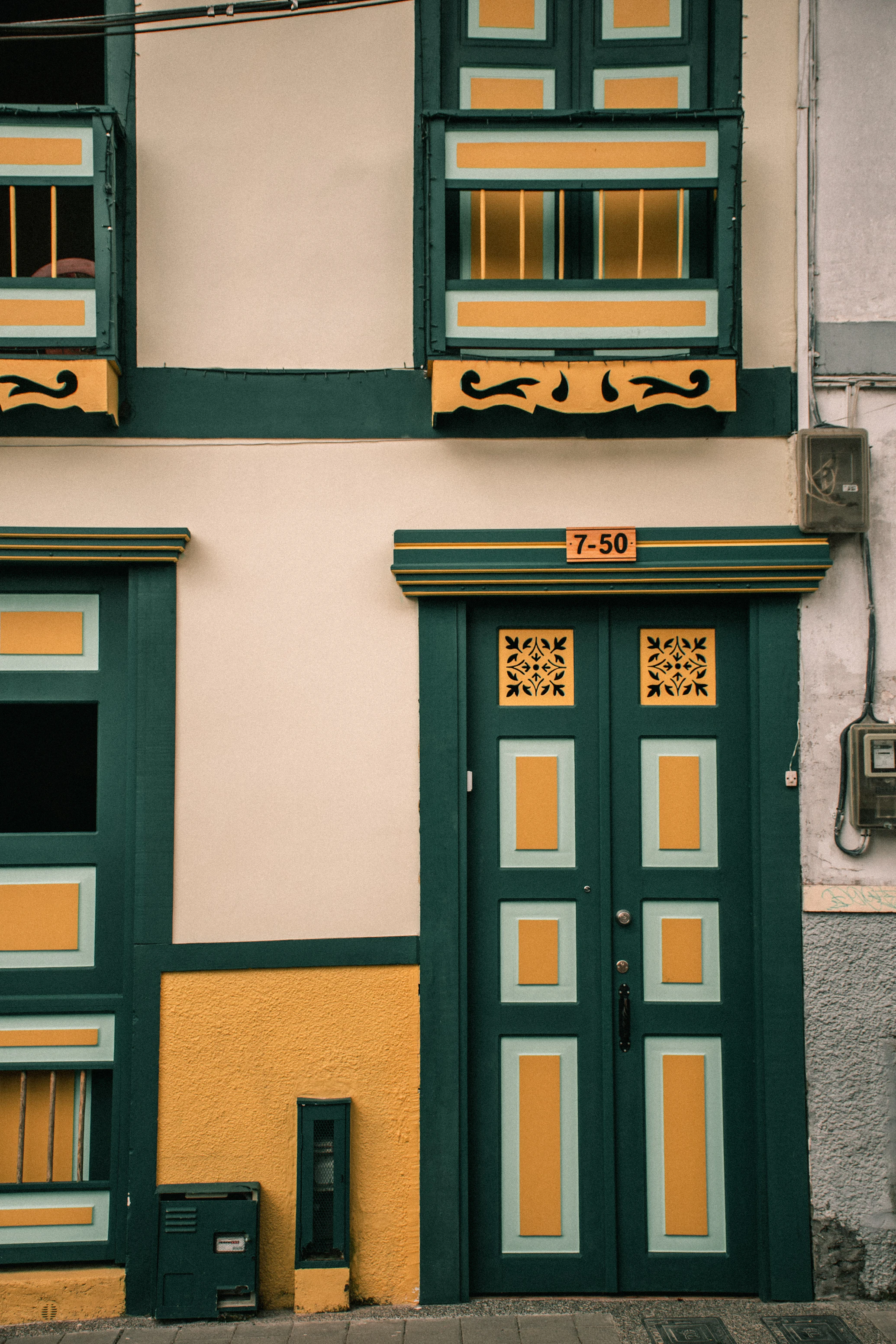 Sunlight hitting a colourful green and yellow building facade