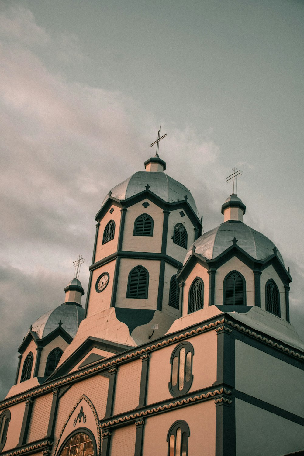 a church with two towers and a cross on top