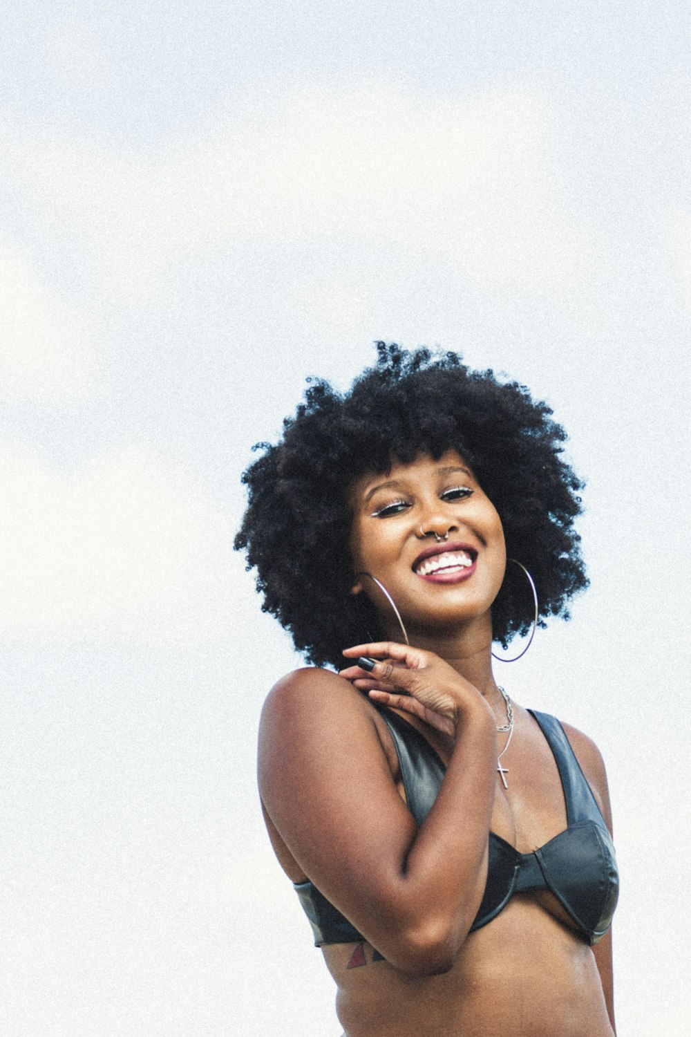 a woman in a bikini is smiling for the camera