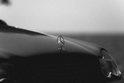 Close-up of a sleek black luxury car hood gleaming after ceramic coating in Kansas City.