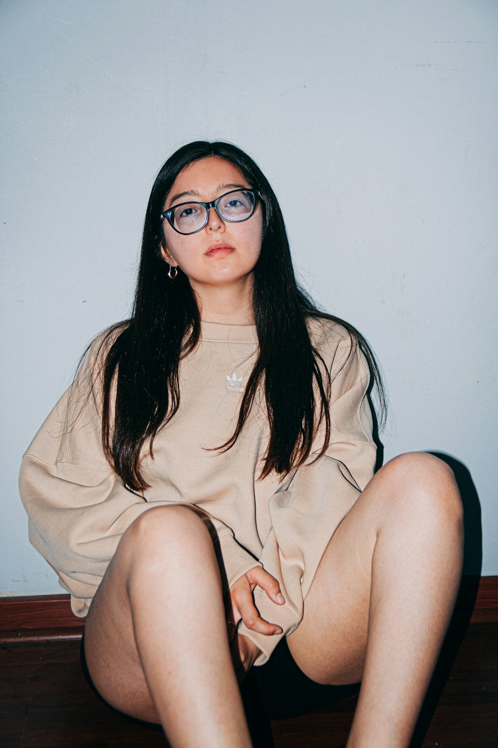 a woman sitting on the floor with her legs crossed