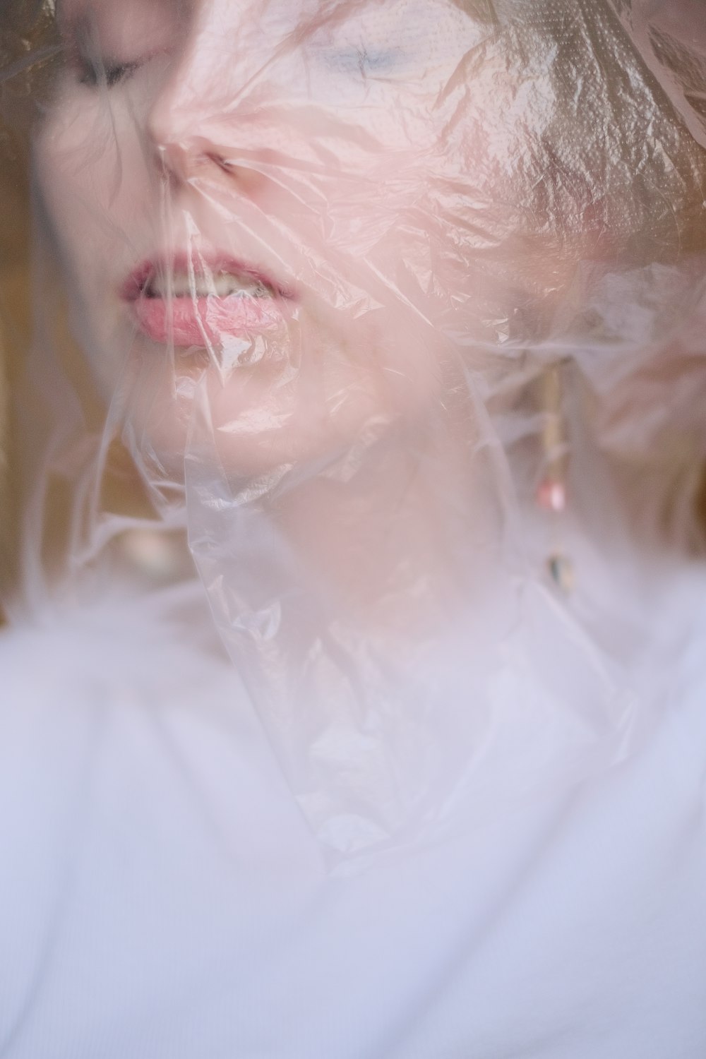 a woman wearing a plastic wrap around her face