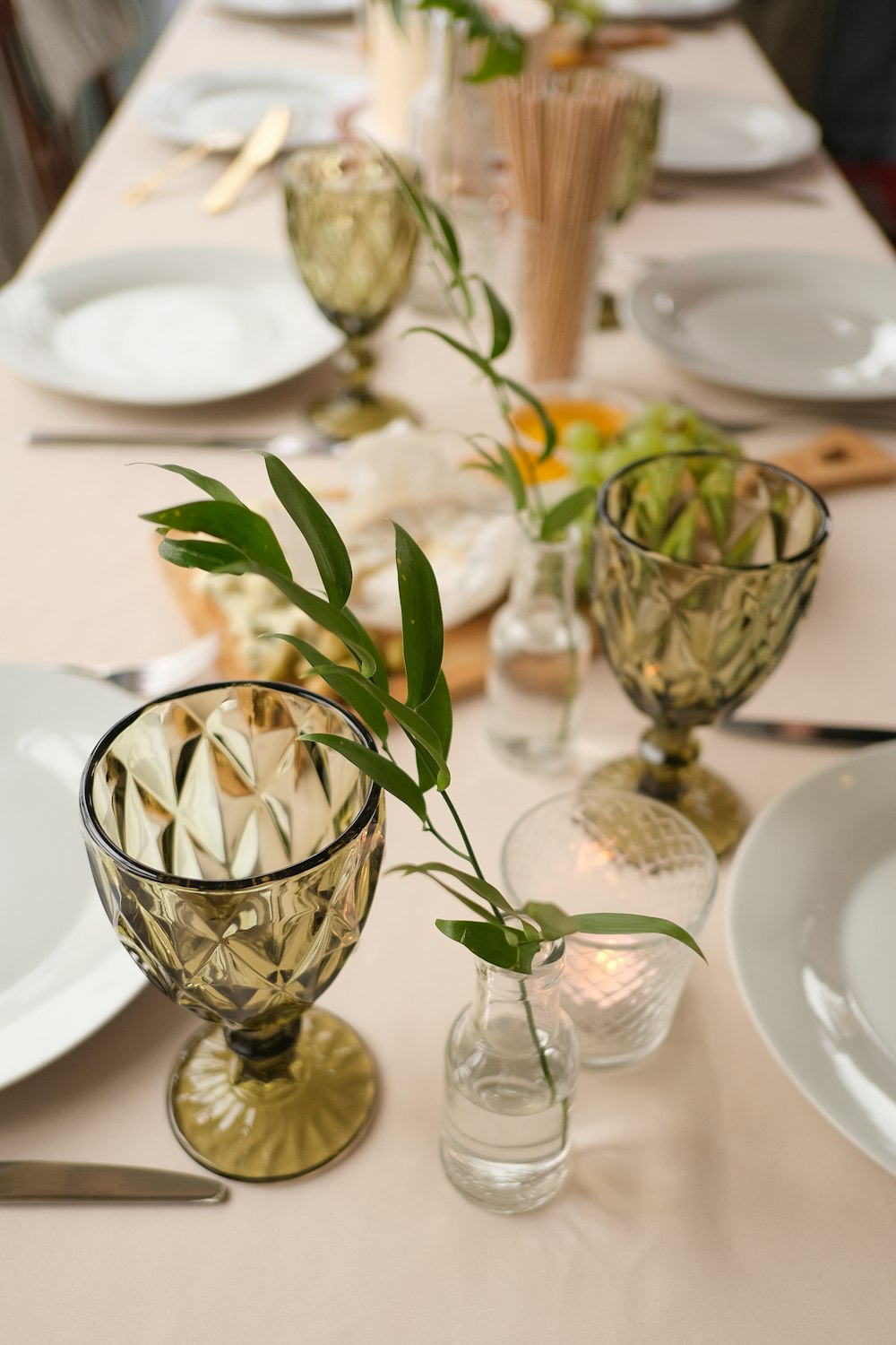 a long table with plates and vases on it