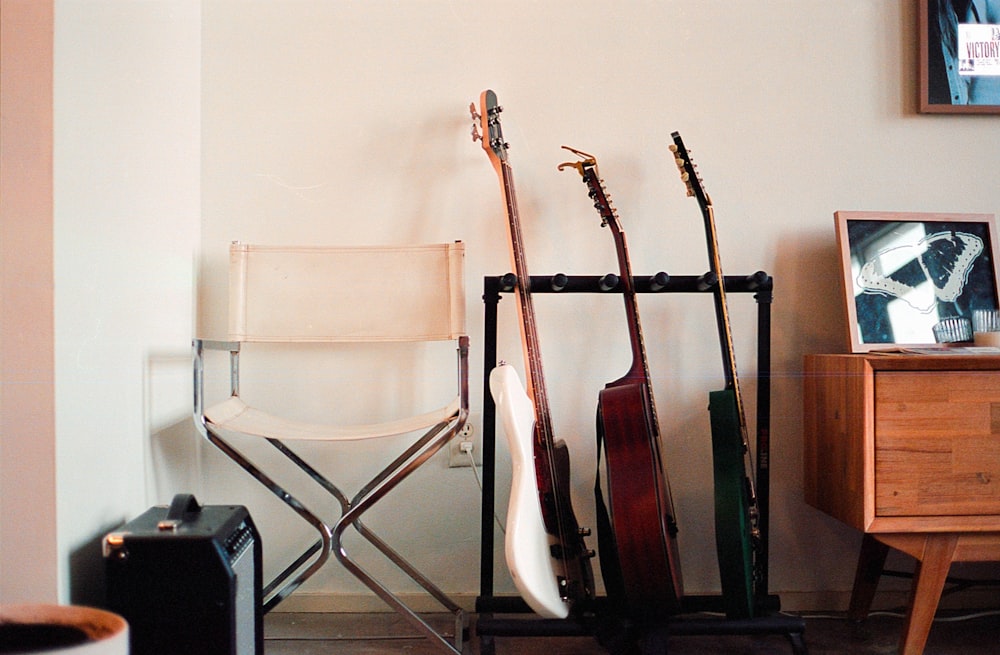 a room with a chair and a rack with guitars