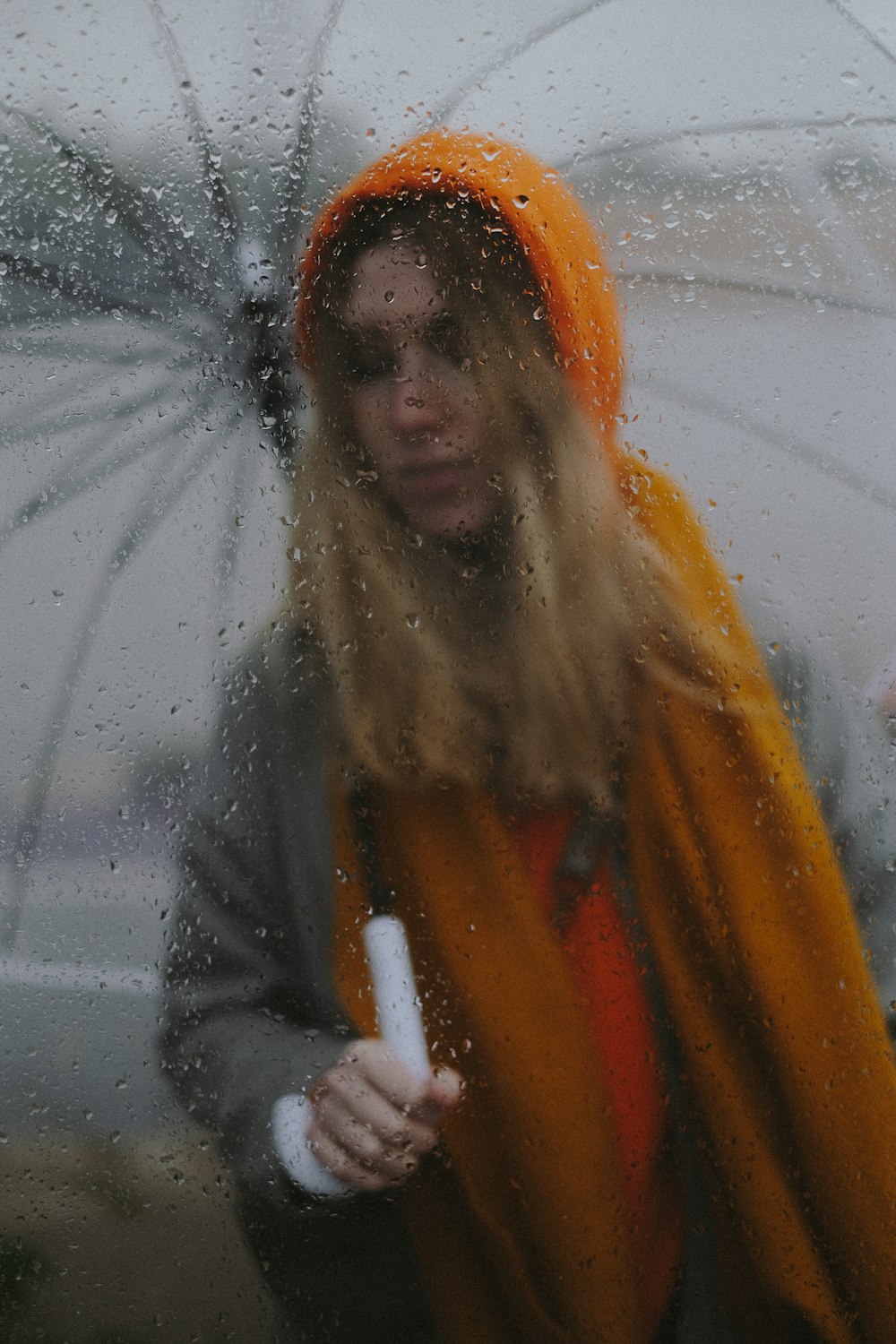 a woman with an orange scarf and an umbrella