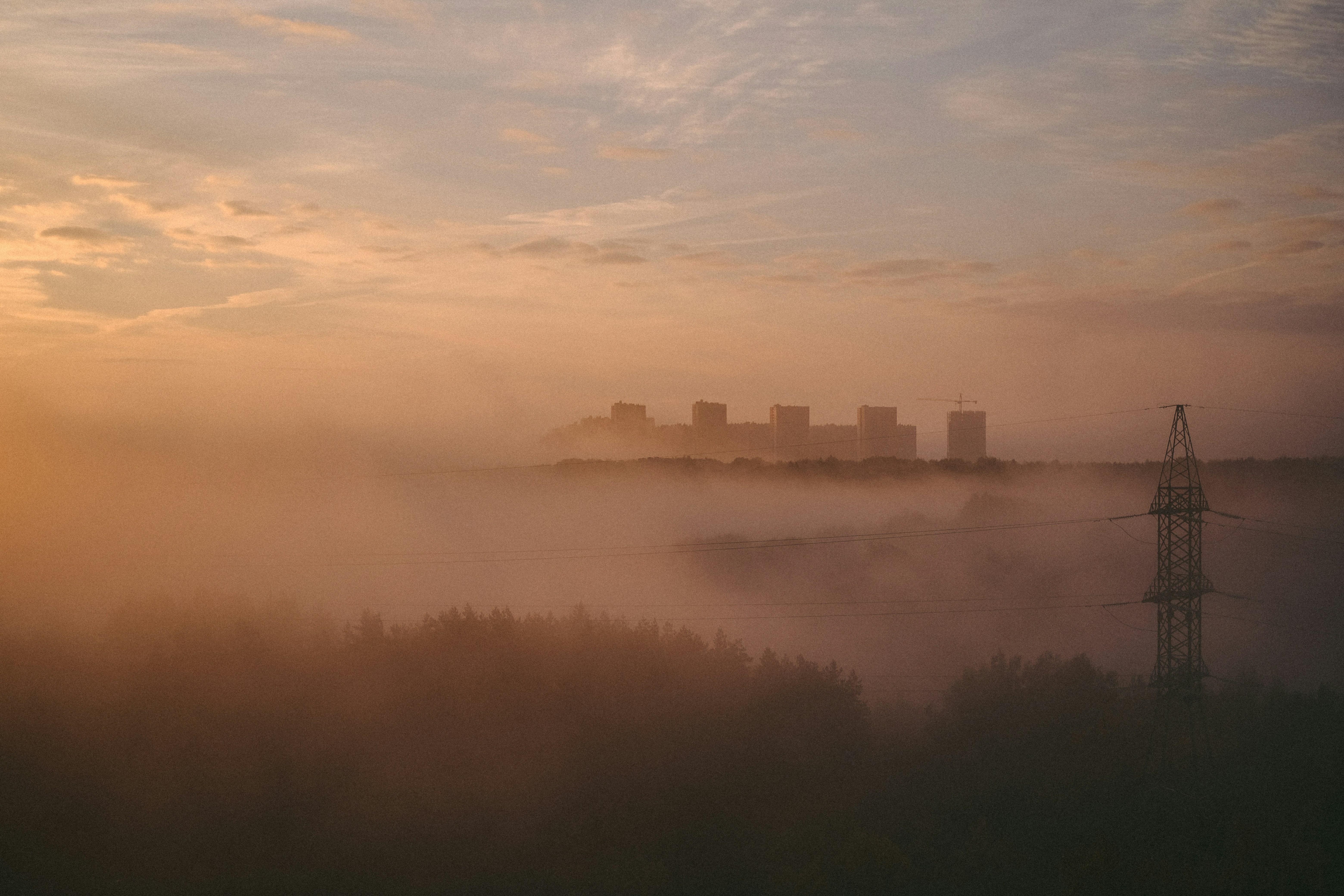 a view of a city in the distance with fog in the air