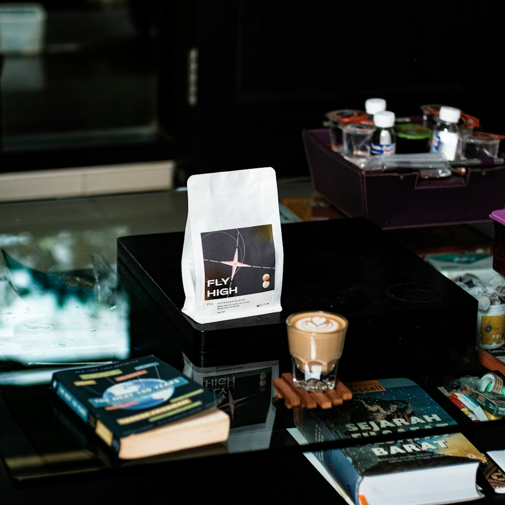 a table topped with books and a cup of coffee