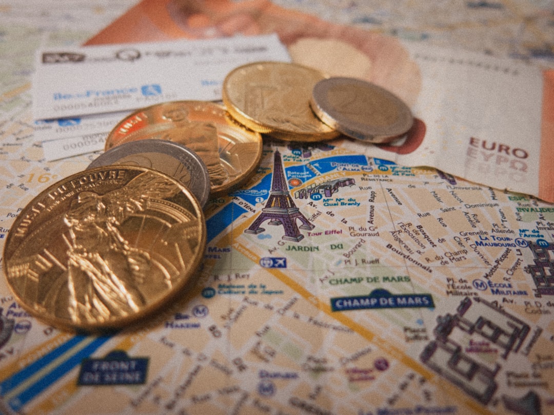 a bunch of coins sitting on top of a map, Paris
