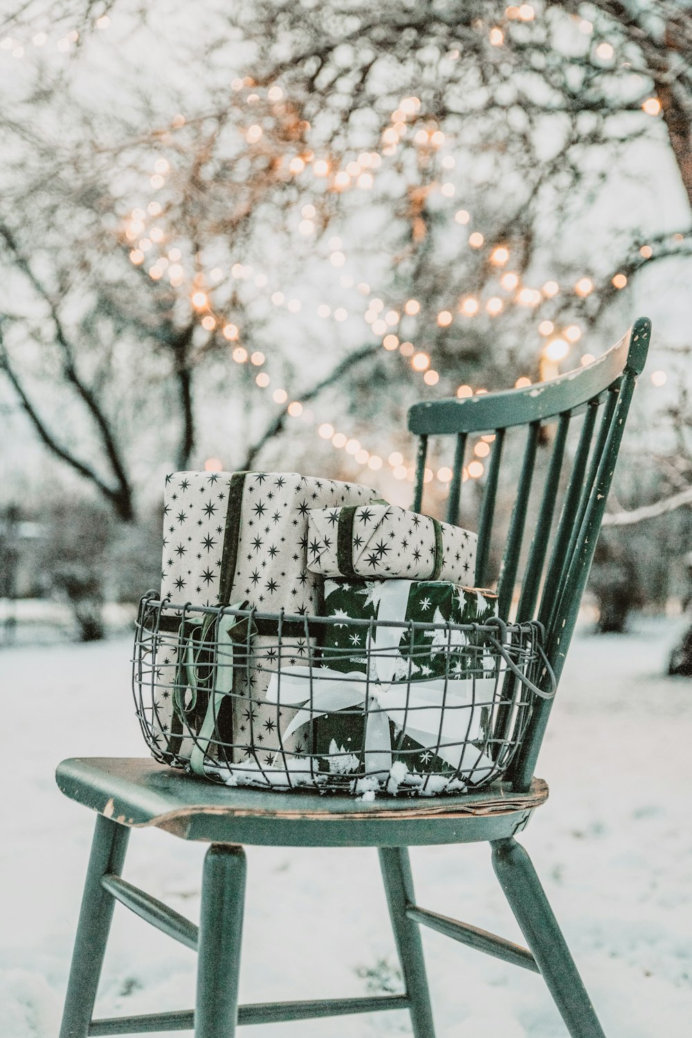 a green rocking chair with a christmas present on it