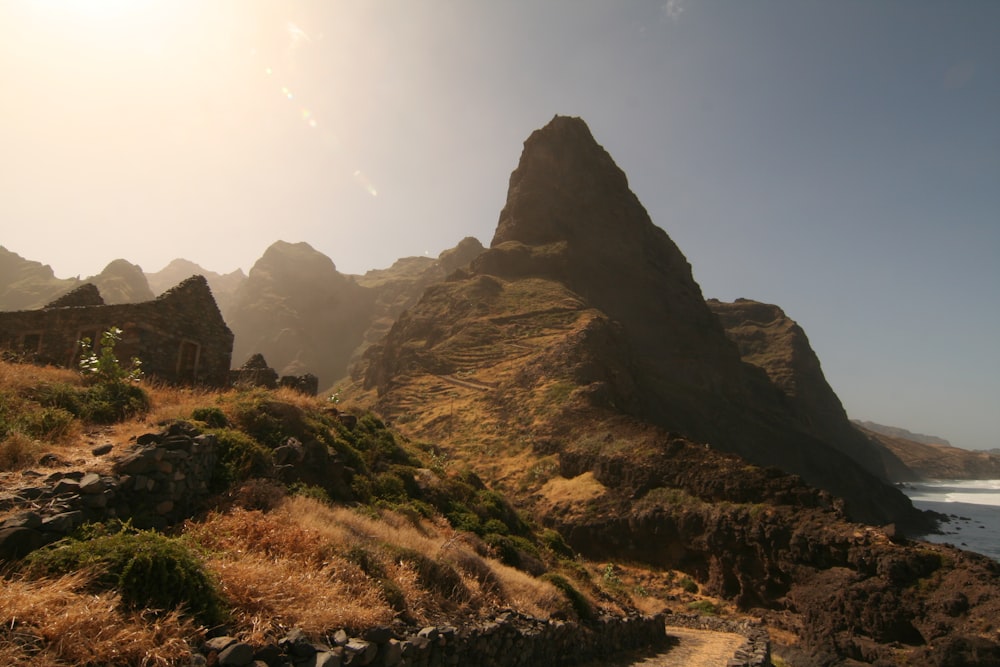 the sun shines brightly on a rocky coastline