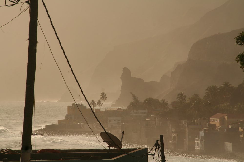 a boat sitting on top of a beach next to the ocean