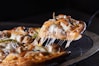 a slice of pizza is being lifted with a spatula