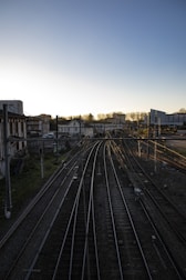 a view of a train track with buildings in the background