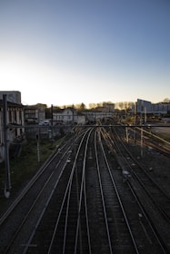 a view of a train track with buildings in the background