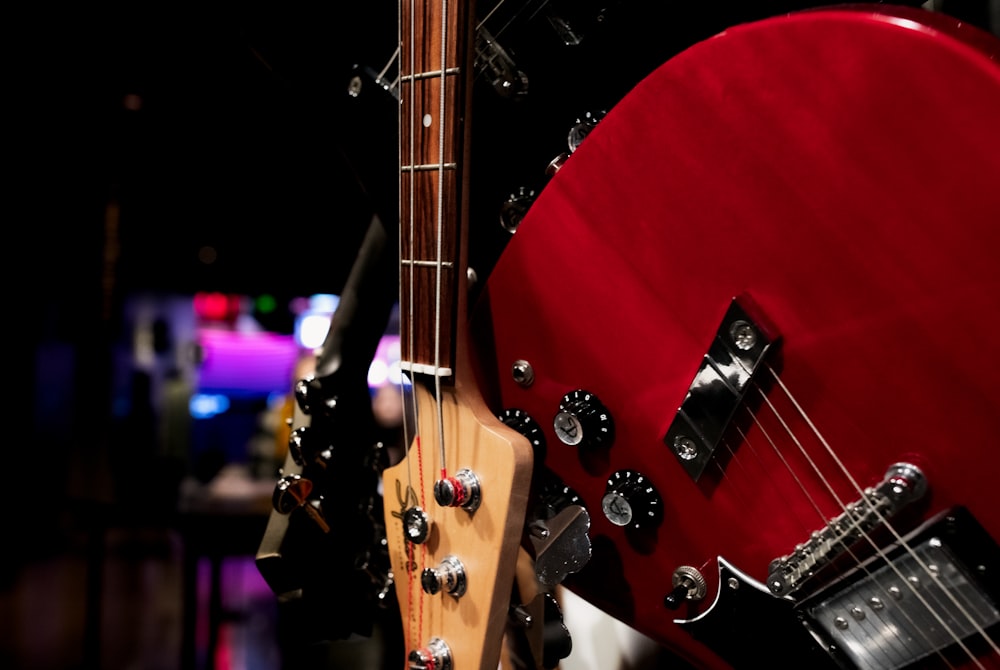 a close up of a red bass guitar