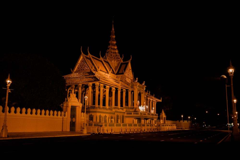 a large building with a clock tower at night