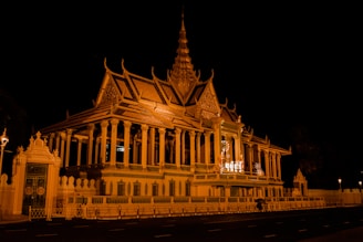 a large building lit up at night with a clock tower