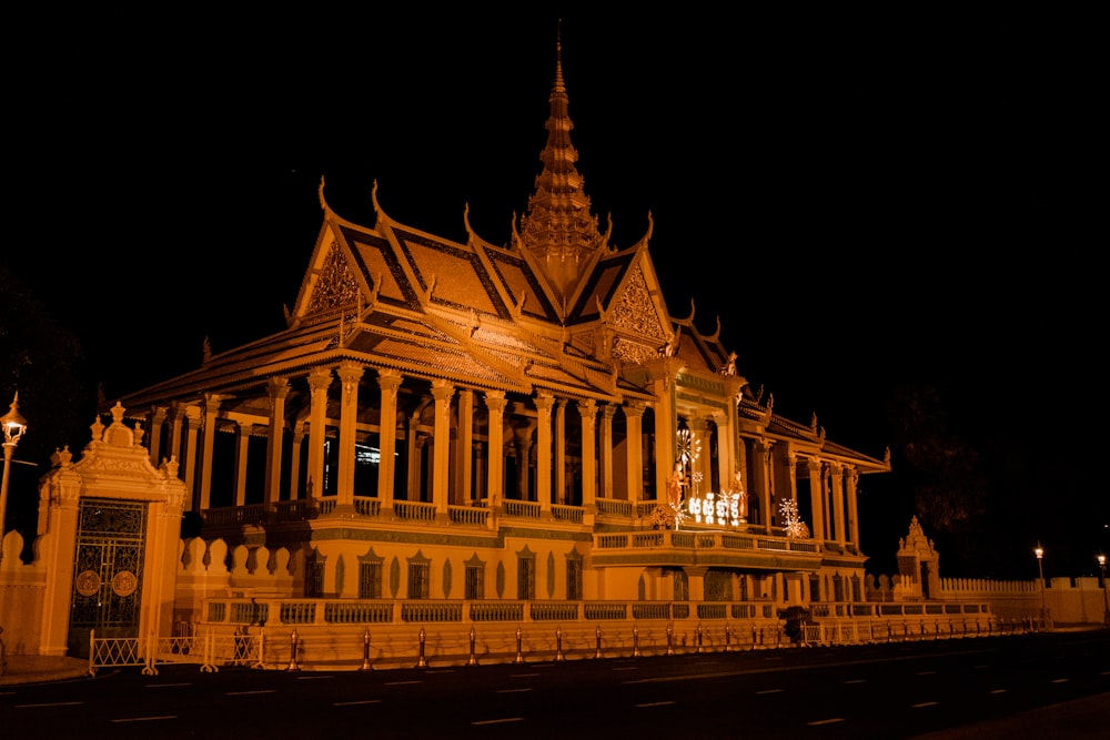 a large building lit up at night with a clock tower