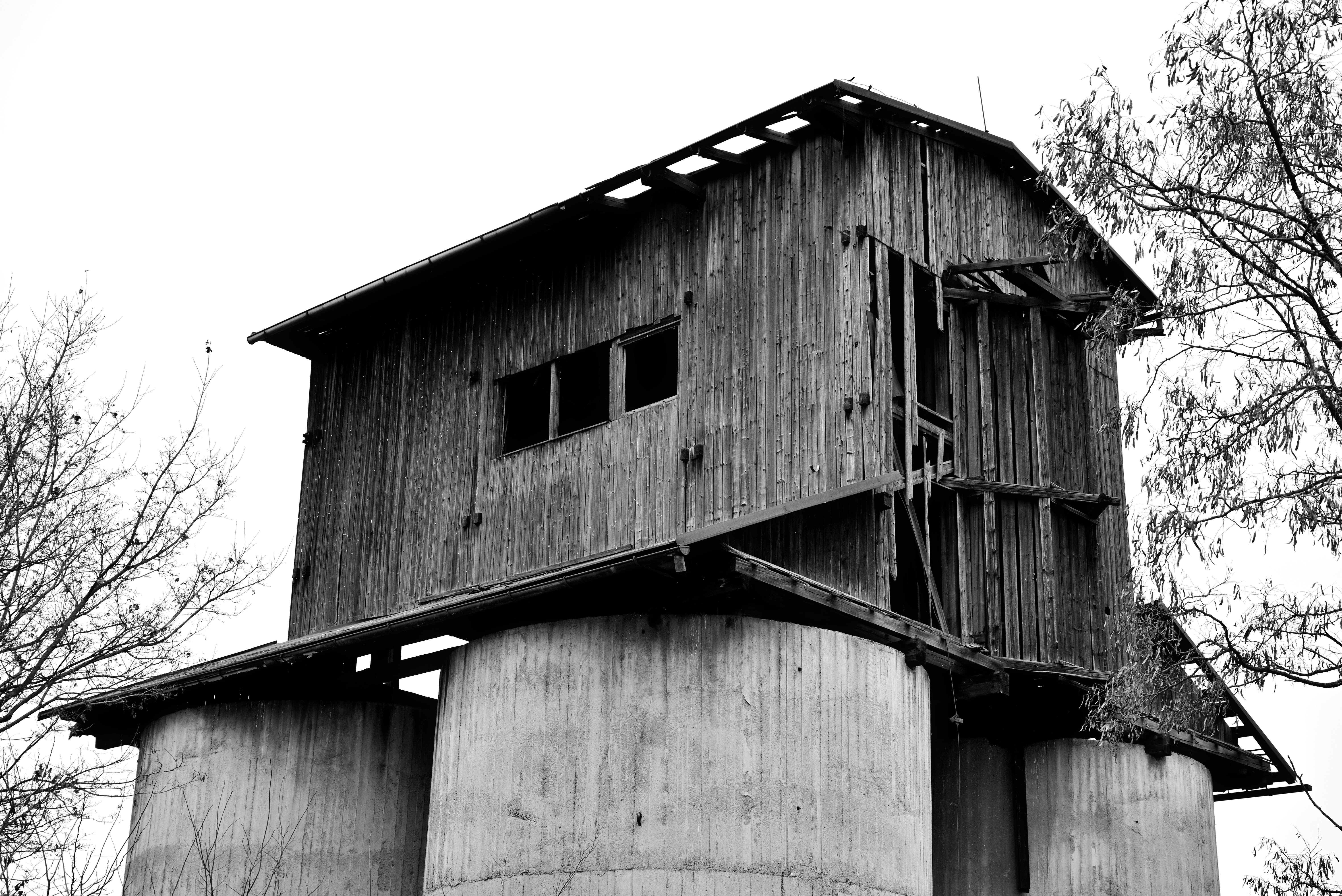 a tall wooden tower sitting next to a tree