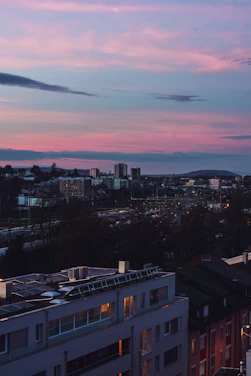 A vibrant African city skyline at dusk with solar panels and green tech installations glowing softly.