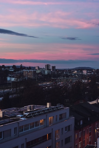 A vibrant cityscape at dusk showcasing solar panels and smart street lighting powered by renewable energy.
